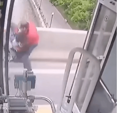 This dynamic photograph captures the pivotal moment when a bus, doors wide open, becomes a refuge of safety. The bus driver, depicted in the act of stopping a distressed woman, stands as a hero in the chaos. The open doors symbolize not just a means of transportation but a haven of security and intervention. The composition conveys a sense of urgency and decisive action, emphasizing the role of the bus driver as a guardian angel in the face of a potential crisis.