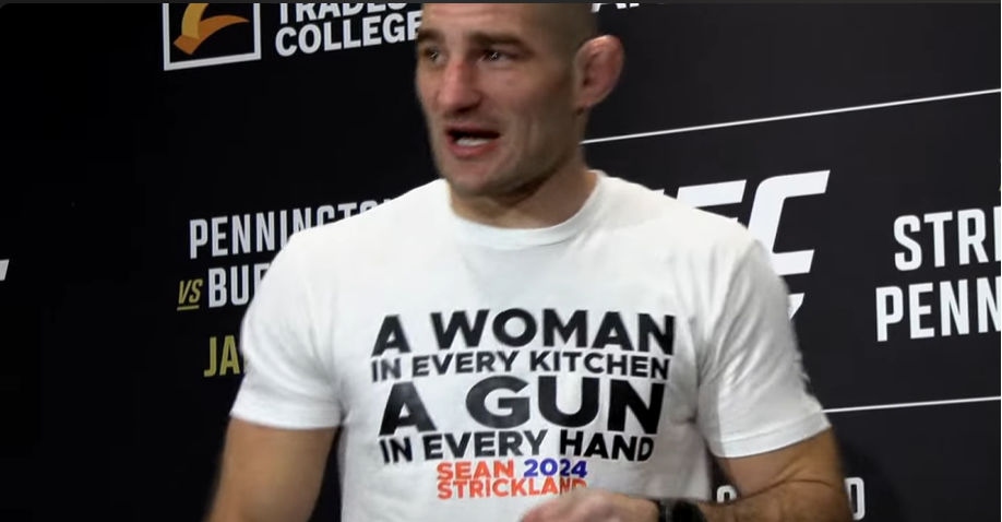 Sean Strickland wearing a T-shirt with a controversial slogan during a press conference