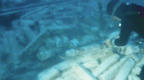 A diver uncovers ancient lead ingots from a 2,000-year-old Roman shipwreck in the Mediterranean Sea.