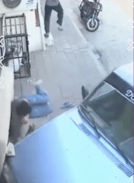  A car colliding with a sofa, narrowly missing the man who was sleeping.