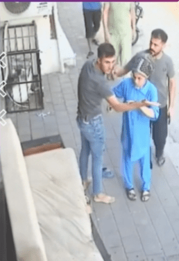 Four people gathered around the man who was sleeping, checking if he is okay.