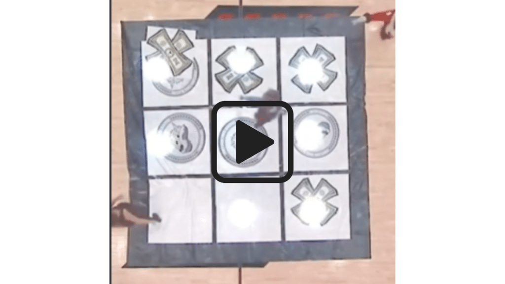Video of Basketball court with a Tic-Tac-Toe board in the center and game pieces on it.