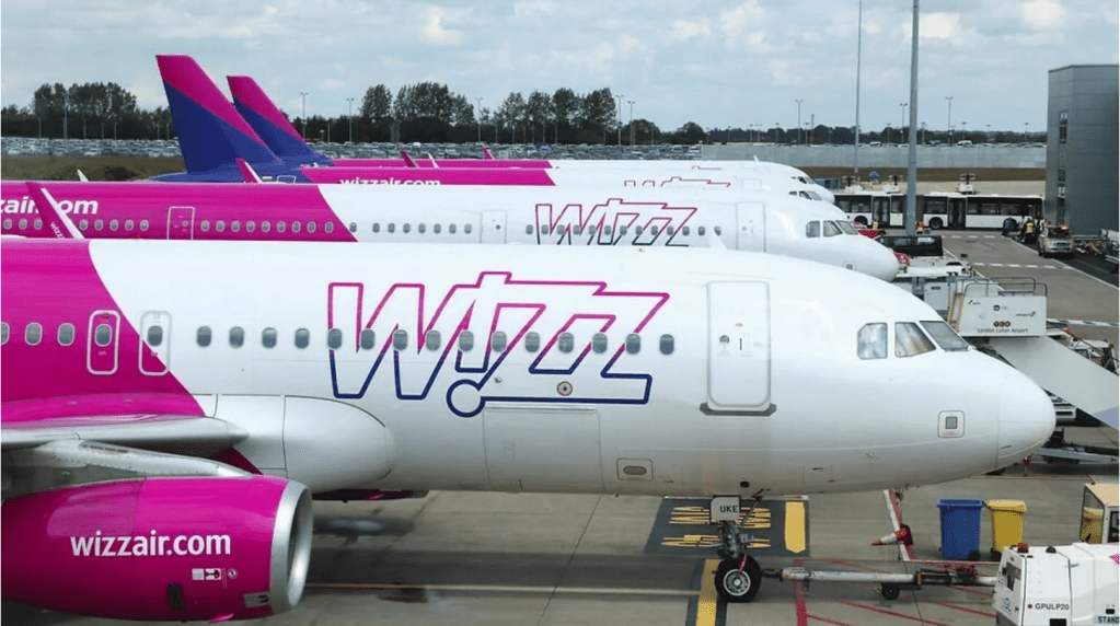 Side view of three Wizz Air planes parked at the airport.