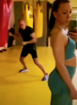 Close-up of the man’s distracted face as he glances at the girl’s pose.