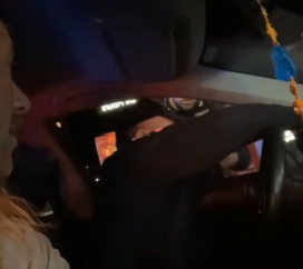  Man in passenger seat offers to translate for the driver to a police officer outside the window.