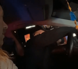 Man in passenger seat offers to translate for the driver to a police officer outside the window.