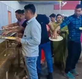A man at a buffet, distracted as another man secretly takes food from his plate.
