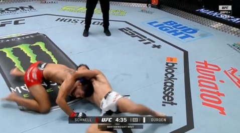 A photo of UFC fighter Cody Durden applying an anaconda choke to Matt Schnell, forcing him to submit.