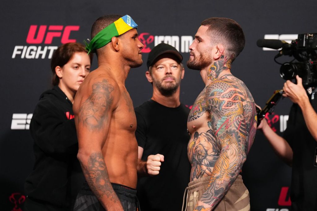 A photo of UFC fighters Gilbert Burns and Sean Brady facing off in the Octagon before their fight.
