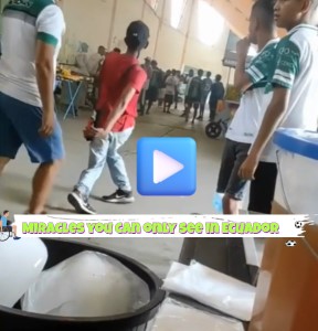 A man in a wheelchair is seen just inside the pitch at a soccer stadium, appearing to have limited mobility.