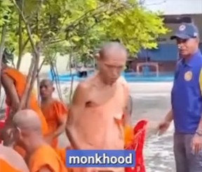 Six Thai Buddhist monks in prison‑style attire standing in a row outside a temple building