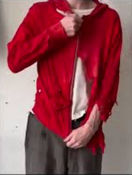 Oversized hoodie with multiple deliberate rips and frayed edges, showing a worn, “destroyed” aesthetic.