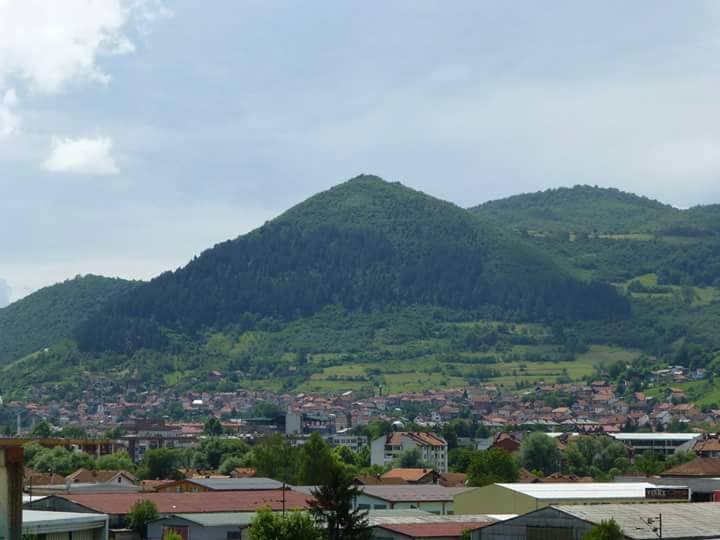 View of the Visočica hills overlooking the town of Visoko, Bosnia, with natural green slopes resembling a pyramid shape.