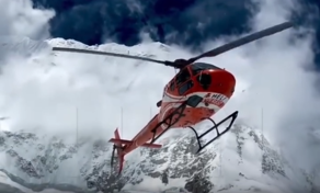 Helicopter performing a rescue operation near Everest Base Camp with climbers below