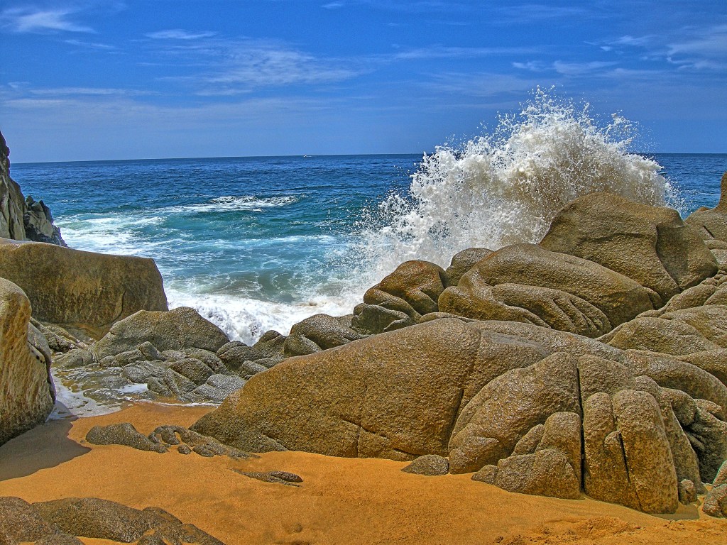 Lover’s Beach in Cabo San Lucas, Mexico, framed by rocky cliffs and clear blue water.