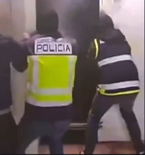 Spanish police officers entering a hidden underground tunnel beneath a warehouse in Ceuta during a drug smuggling raid