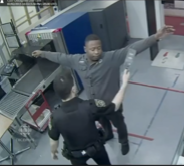 A man walking through a metal detector in a high-security facility setting.