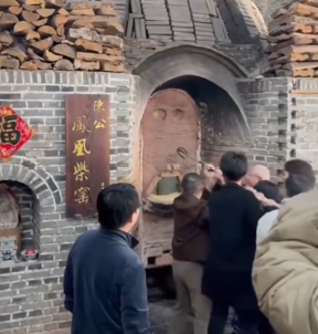 A traditional wood-fired Jingdezhen kiln glowing orange as porcelain is fired at high heat.