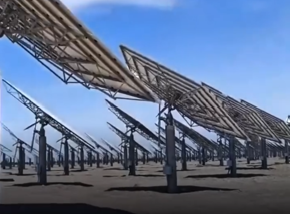 A futuristic solar tower in a desert surrounded by thousands of mirrors reflecting sunlight toward the top.