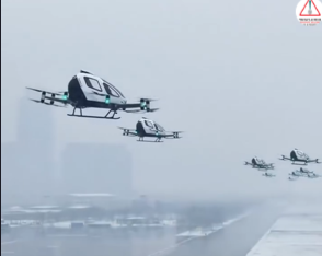 A flotilla of futuristic flying taxis flying in formation above a city.